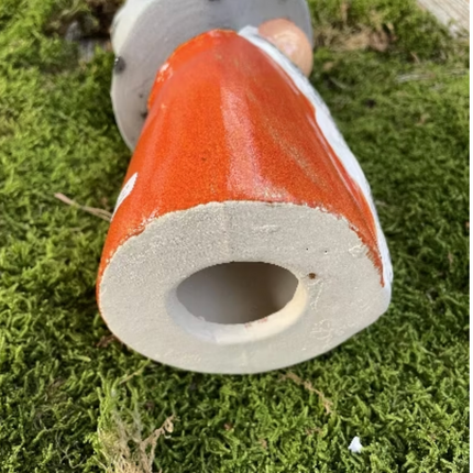 Picture of the underside of a gnome showing a small hole allowing the gnome to be placed on a garden stake of set flat on the ground