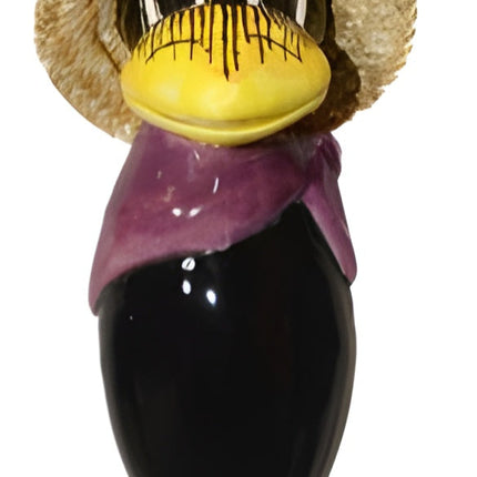 Raven with and straw hat and purple scarf from Goose and Company