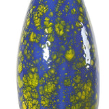 Colorful cat-shaped object with blue body and yellow spots on a white background from Goose and Company